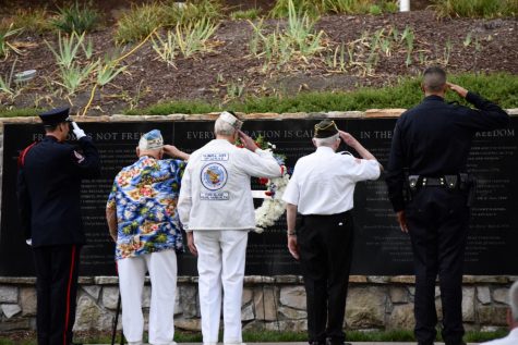 A San Ramon Valley Fire Department Guard of Honor, two Pearl Harbor survivors and a San Ramon Valley police officer (from left to right) salute the All Wars Memorial at the All Wars Memorial Park during the raising of the flag. The flag-raising was the last event of San Ramon Valleys 12th 9-11 Remembrance Ceremony.