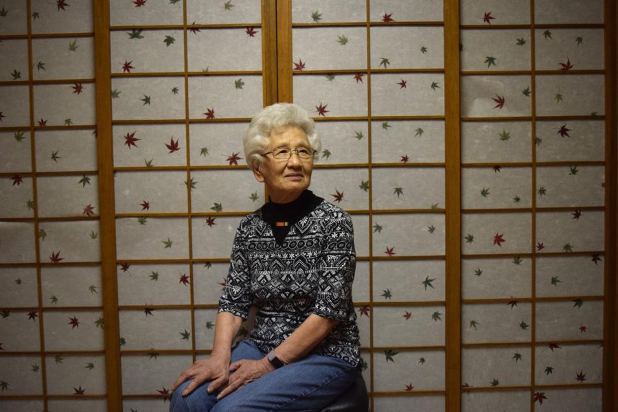 Takeko sits in front of the shoji doors her husband built.