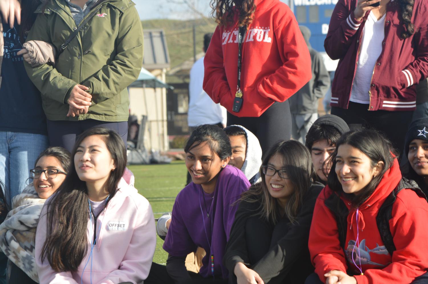 Onlookers smile as Miss Relay winner Rahul Reddy, senior, dramatically demonstrates his catwalk, flaunting a royal purple robe and black cotton socks.