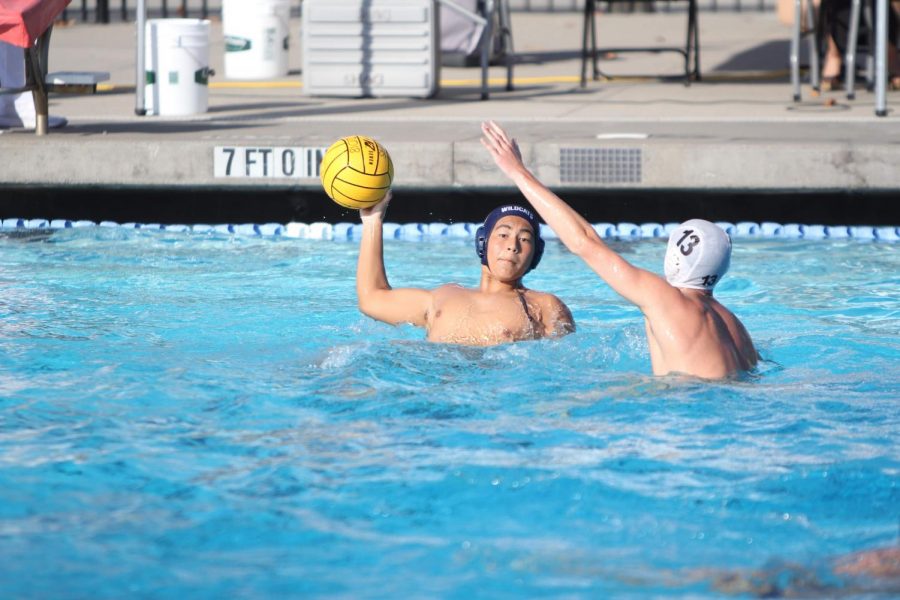 Junior Kyle Takeuchi scans the pool for a teammate to make a pass to.