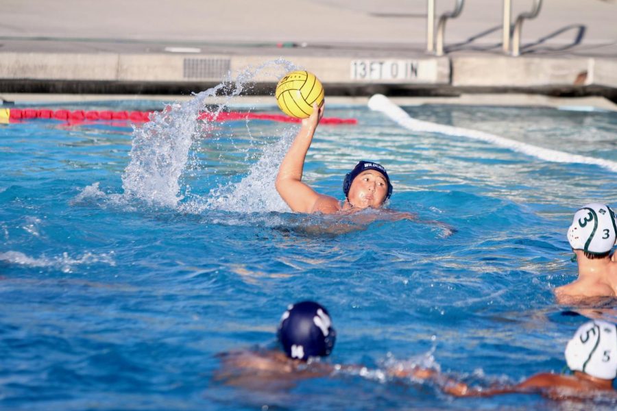 Senior David Wong carries the ball towards the goal, ready to score.