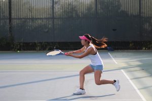 Junior Jasmine Lam prepares to strike the tennis ball.