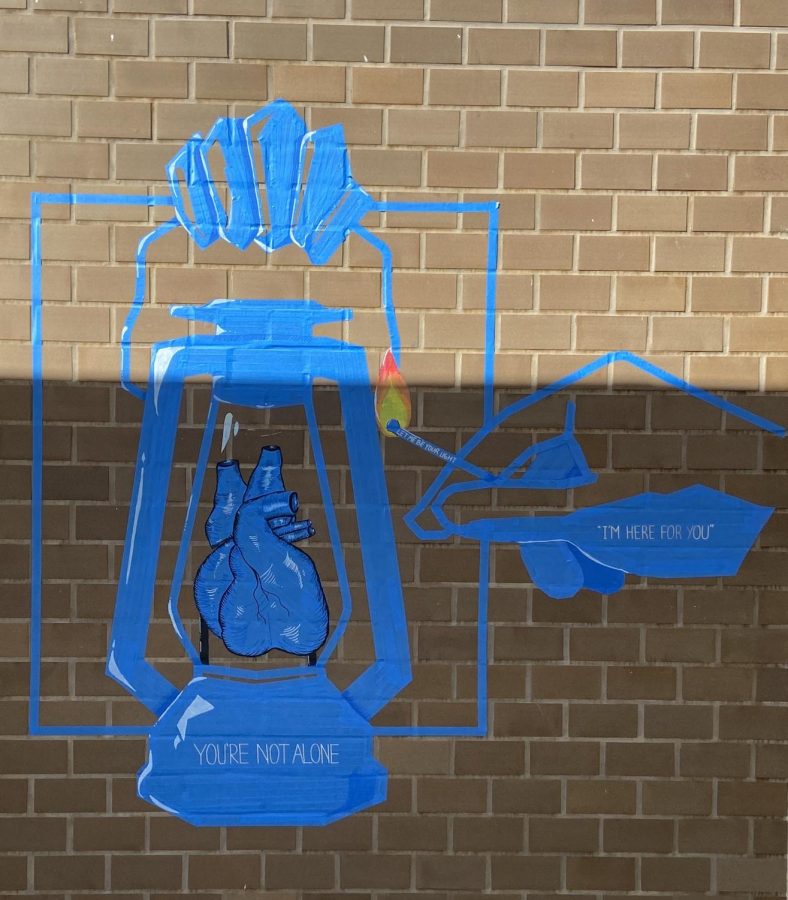 Thanvi Anand, Rhea Park, Dorothy Yeung and Calista Koo created the stunning piece on a brick wall. A heart is formed, encased within a lantern. Inscribed in small letters on the lantern: “You’re not alone.” On the reaching hand: “I’m here for you.”