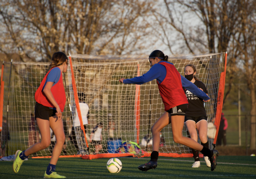 Two San Ramon FC players attempt to score a goal during a team shooting drill. 