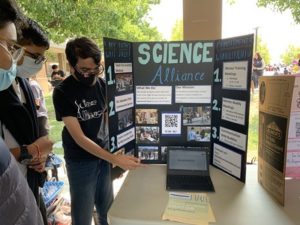 Anirudh Basu, senior and co - president of Science Alliance, introduces his club to potential members during in-person Club Day. 