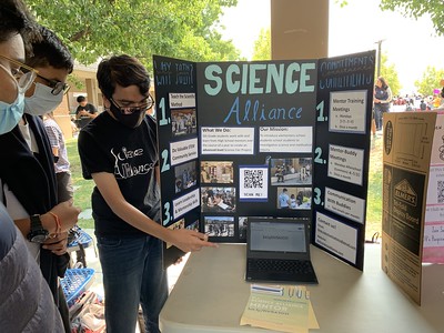 Anirudh Basu, senior and co - president of Science Alliance, introduces his club to potential members during in-person Club Day. 