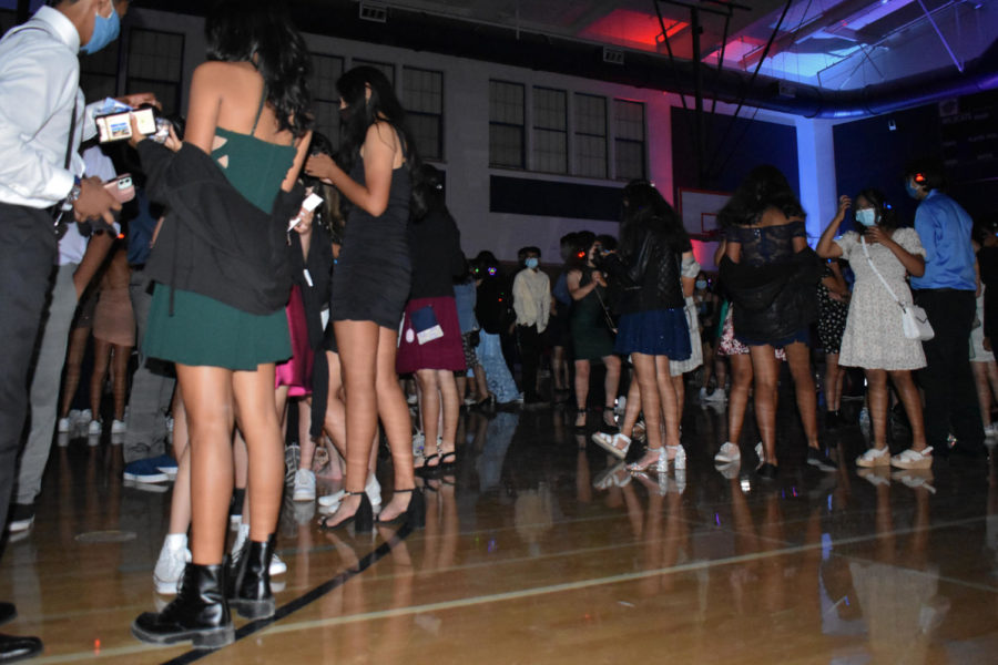 Wearing dresses, button-ups and other formal wear, guests relish the opportunity to spend time with friends at the Homecoming dance.
