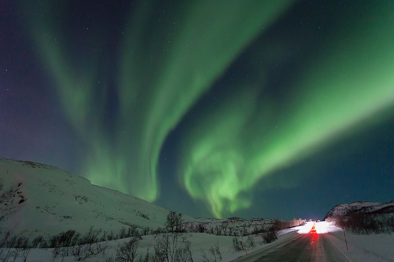 A+majestic+green+aurora+lights+up+the+sky+in+the+dark+in+an+area+filled+with+snow