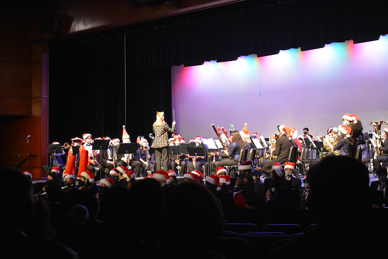 Ending+the+winter+concert+on+Dec.+7+with+a+bang%2C+Symphonic+Band+1+and+the+two+Wind+Ensembles%2C+along+with+Band+Director+Teri+Musiel%2C+changed+into+festive+attire+to+perform+their+last+song+%E2%80%9CSleigh+Ride%E2%80%9D+together.+