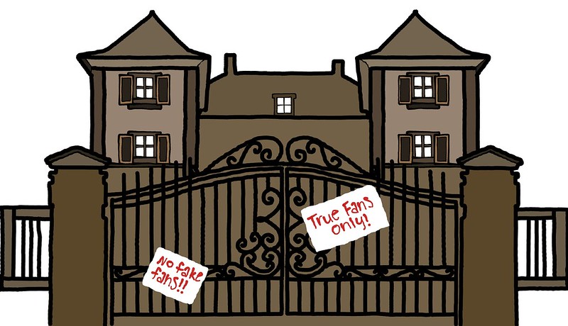 A brown haunted-looking house is blocked with a black gate, with signs that say true fans only.