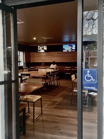 A cozy, warm ambiance and the hum of television shows for all ages greets customers while walking into Sliver Pizzeria, with a handicap label presented at their front entrance.
