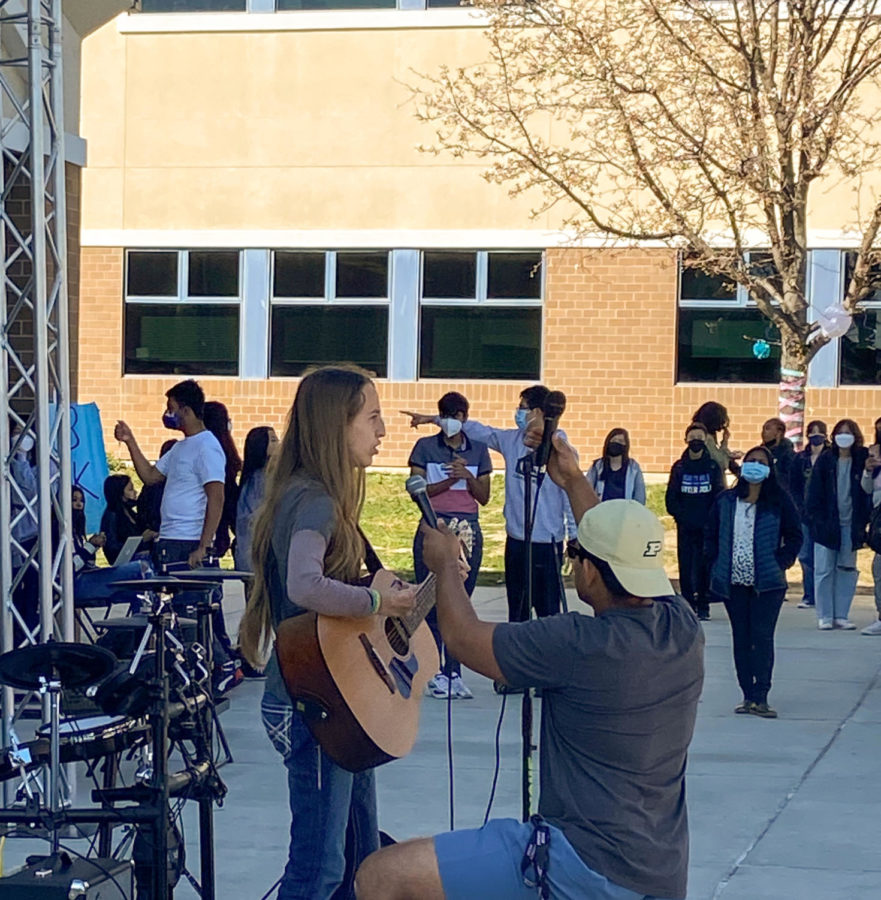 Maria Matos (freshman) sings “Love Story” by Taylor Swift accompanied with acoustic guitar tunes while Akhil Nambiar (senior) holds a mic due to a technical difficulty.