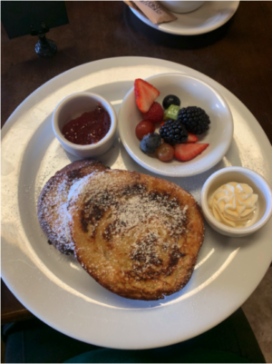 Café Atilla's delicious french toast that comes with an assortment of fruits and extra condiments to add on top.