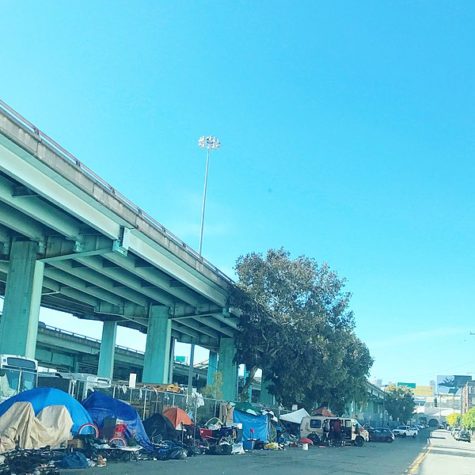 Under the freeway, homeless tents are lined up in San Francisco. 