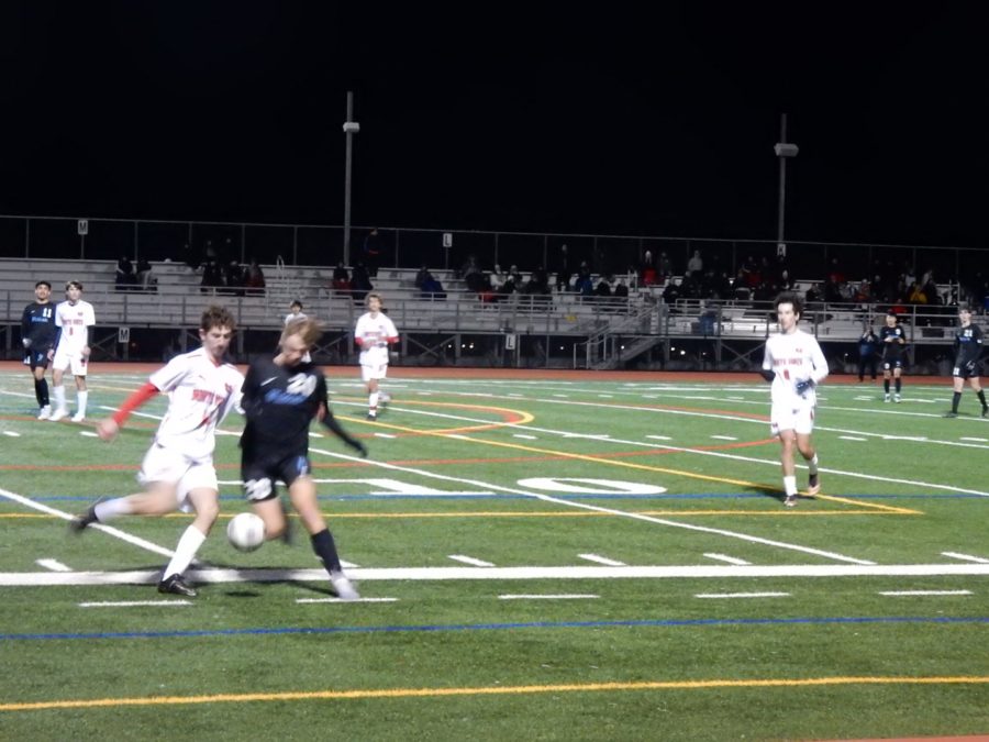 Monte Vista and Dougherty Valley male soccer players head towards the ball in the middle of their heated EBAL game. 