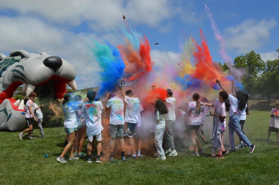 Participants celebrate finishing the race with a group powder toss.