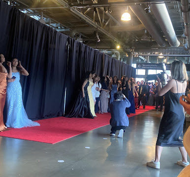 A red carpet at the entrance to the prom where students would walk down and get their photos professionally taken.