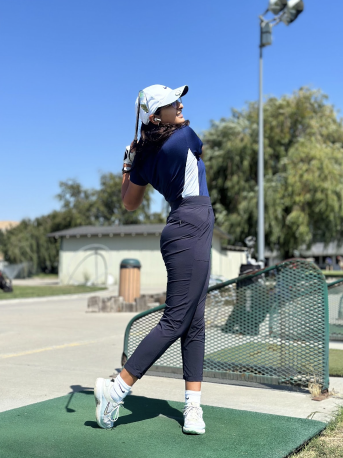 Sophomore Dia Chopra practices her golf swings for the upcoming season.