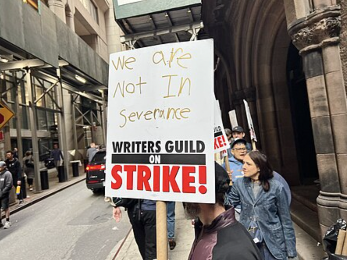 Writers on strike form a picket line outside of Marvel Disney+ Studio in New York City, with message in reference to popular tv show Severance //Wikipedia
