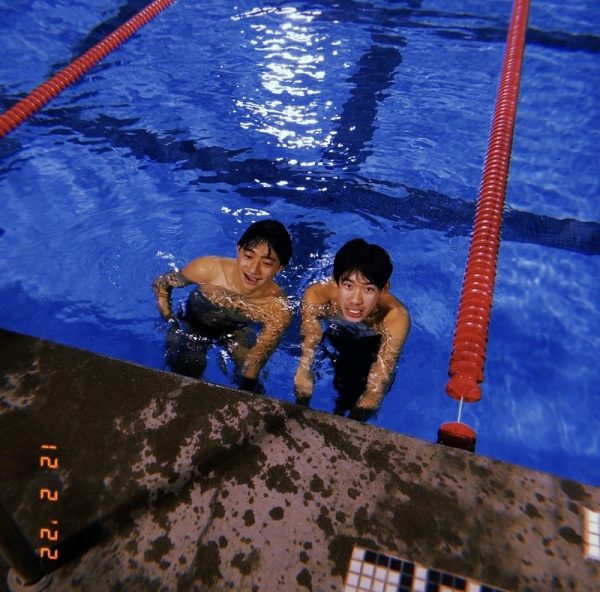 Senior Bryan Yan (left) swims next to longtime friend Junior Ben Hu (right) at night