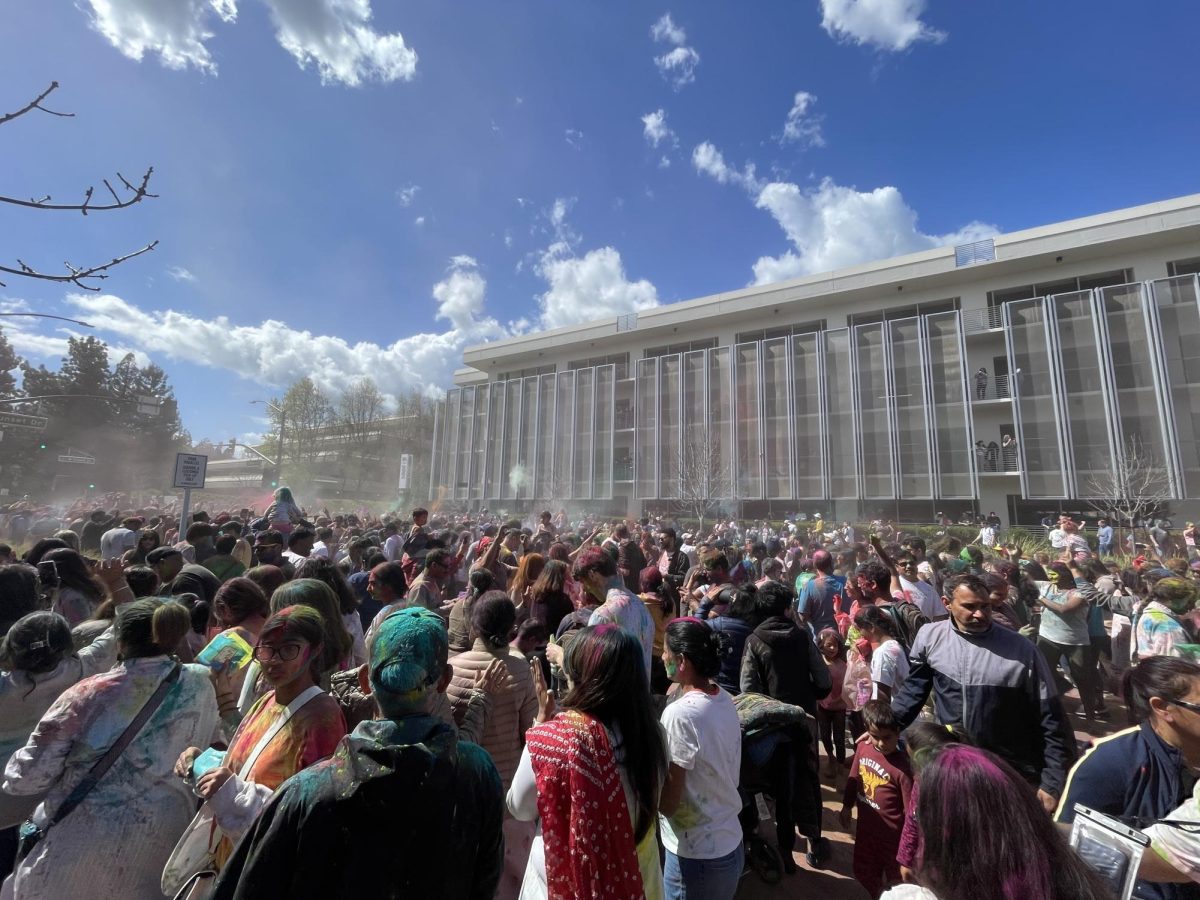 A crowd stands outside of San Ramon City Hall, celebrating Holi.