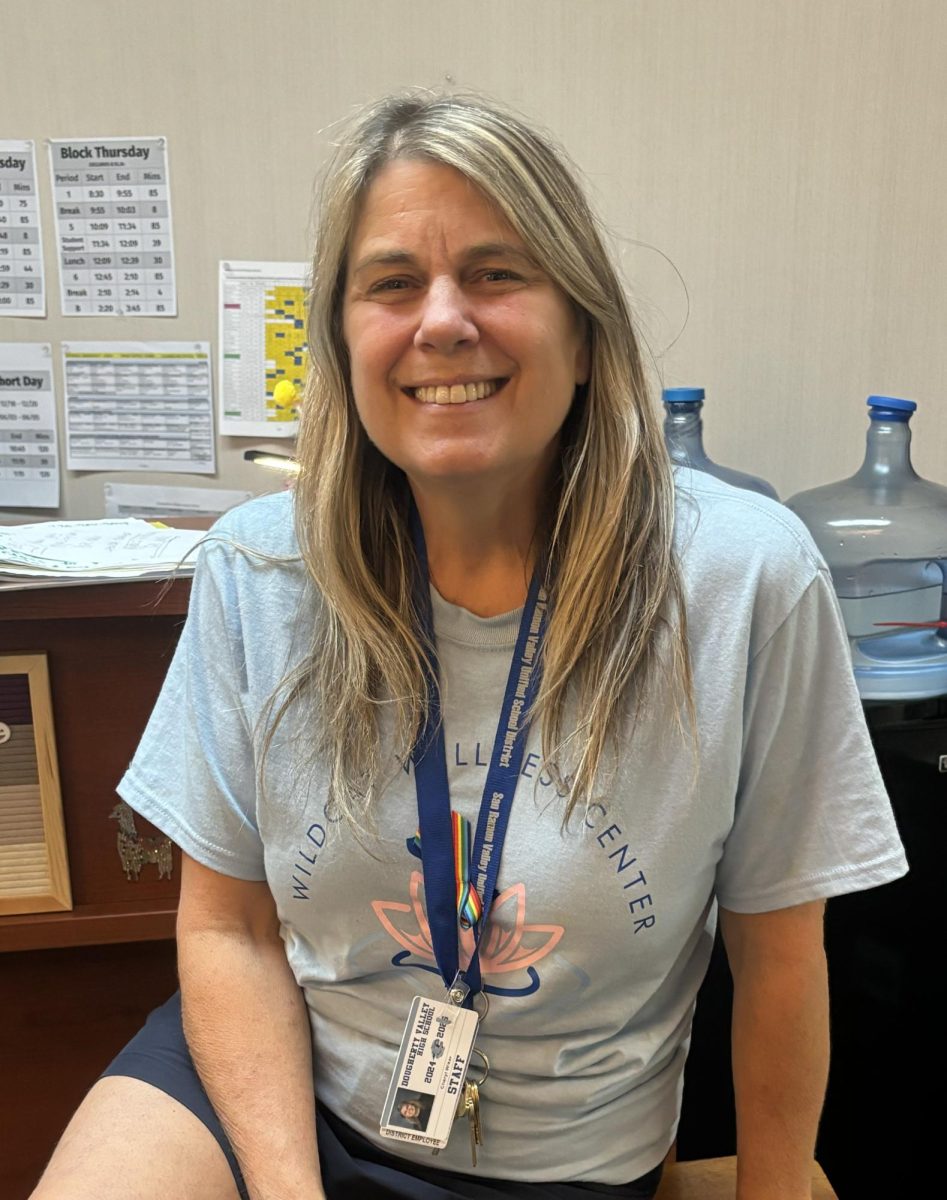 Ms.Cheryl sits at the front desk in the wellness center.
