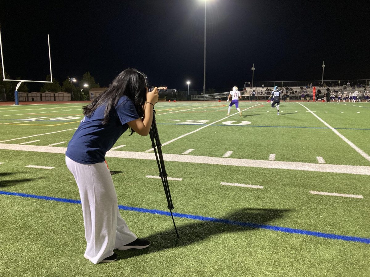 Yearbook Photography Editor junior Eka Yang chronicles the Homecoming game from the sidelines. 