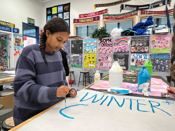 Leadership student junior Manna Sahle prepares a sign for the Winter Carnival, which will precede the night rally on Dec. 13.