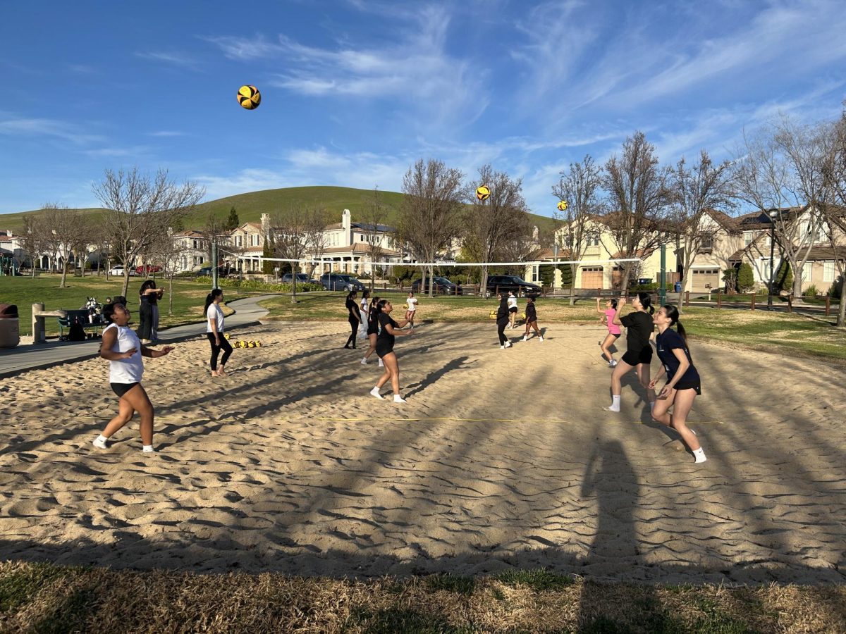 From left to right: students Addasyn Samson and Livia Kristic tryout for beach volleyball at Bellingham Square Park