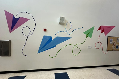 The paper airplane mural is on display in the 3000s building.