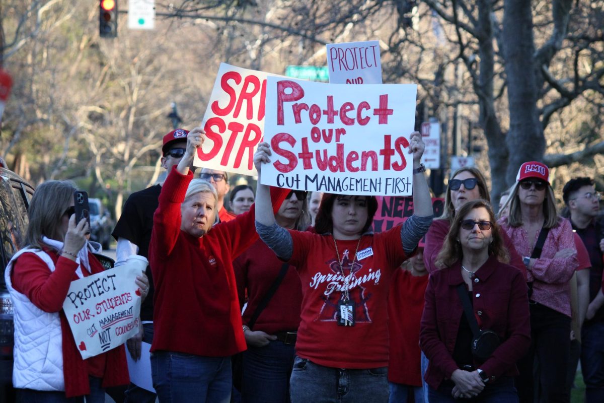 Teachers rallying from various schools across SRVUSD held signs protesting the effect of cuts on student education. 