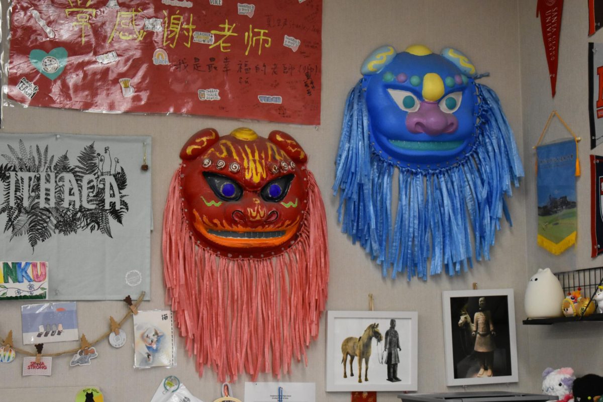 Two painted Chinese lion heads hang on the wall of the Chinese classroom, one of the many classrooms on campus that feature this cultural project.