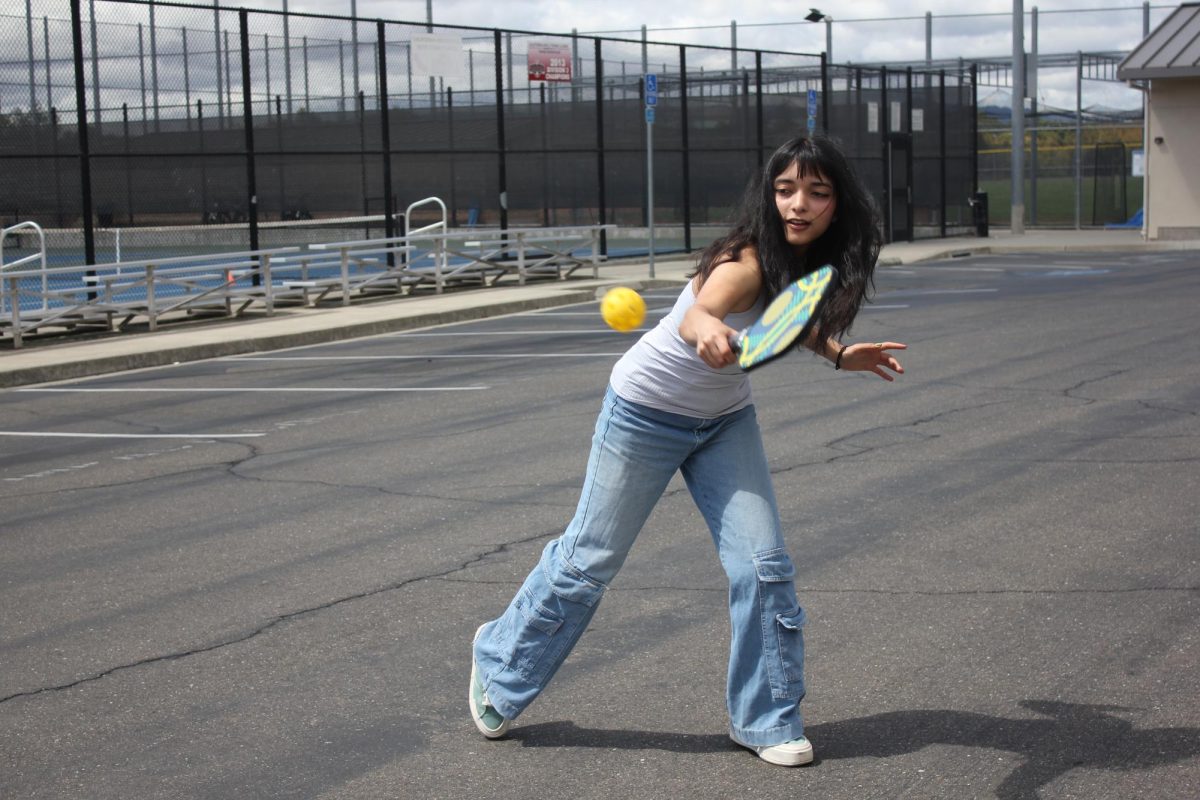 Senior Bhavya Bartwal plays pickleball in the DVHS parking lot.
