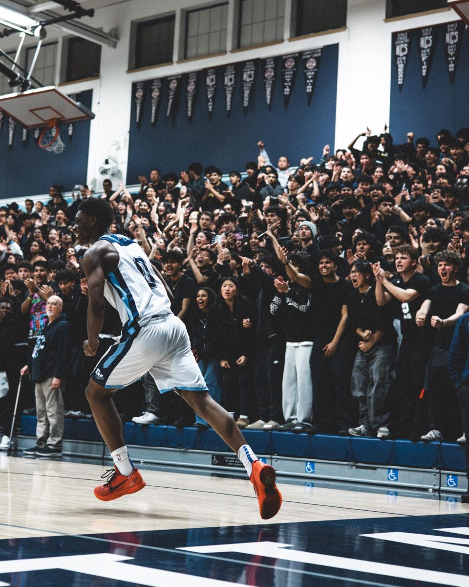 Sophomore Alonzo Walker III running past the DVHS student section.
