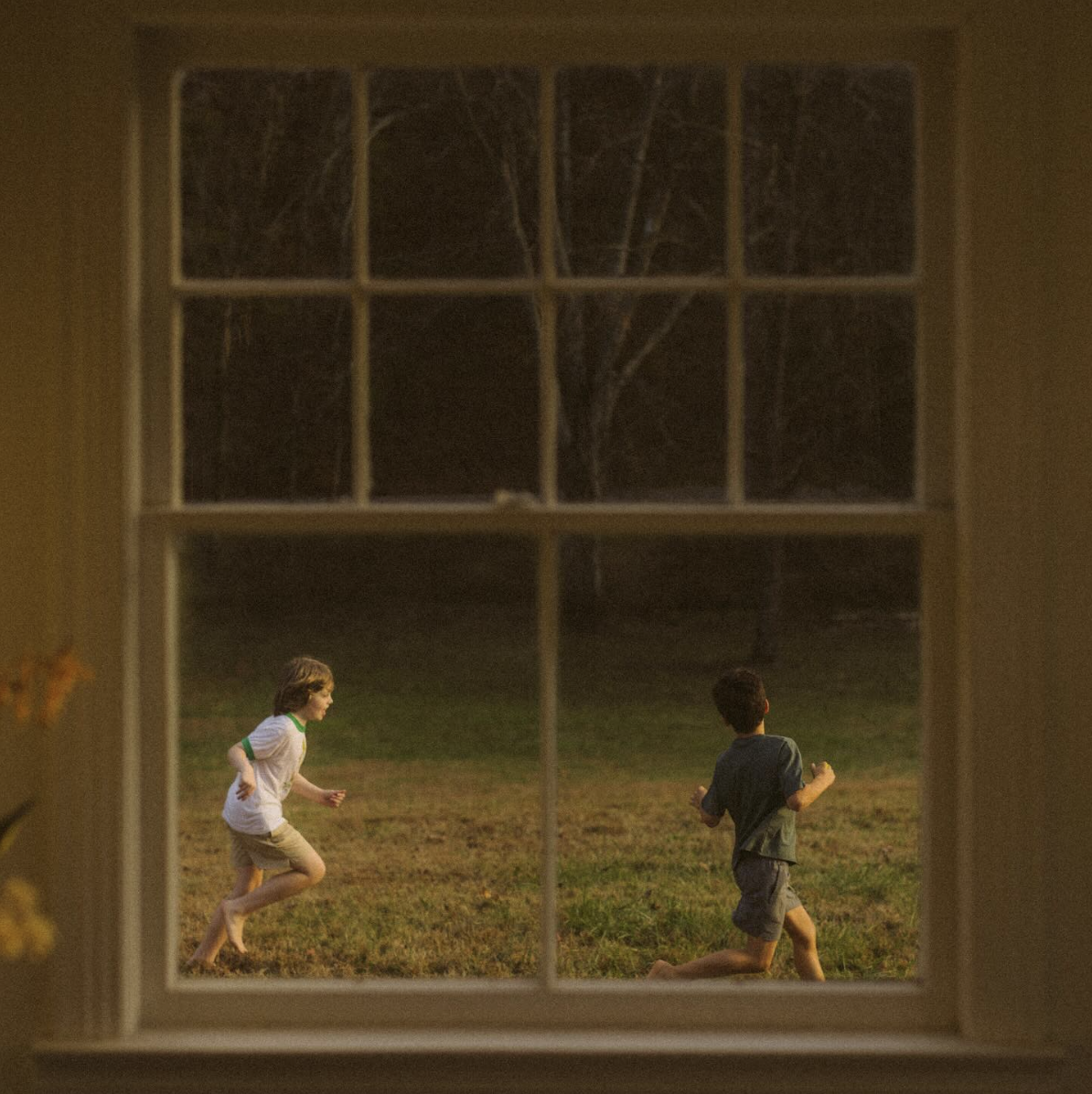 "The Great Divide"'s album cover offers a glimpse into Kahan's childhood, with the window serving as a symbol of separation.